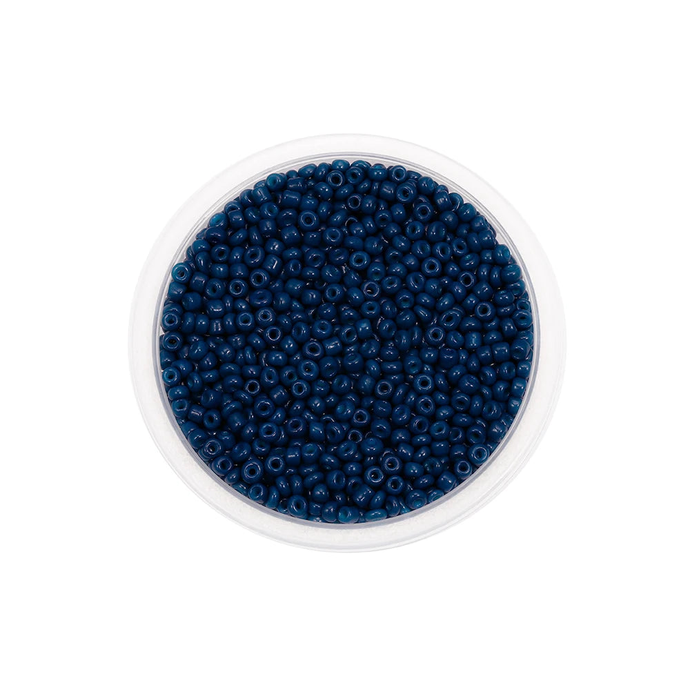 A clear container filled with dark blue Czech glass seed beads for jewelry making