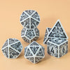 A set of seven polyhedral dice in black and white on a light background.