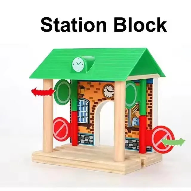 A green wooden station block playset with an arched entrance and decorative elements for railway play.