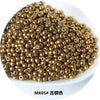 A pile of gold-colored electroplated metallic glass beads for jewelry and crafting.