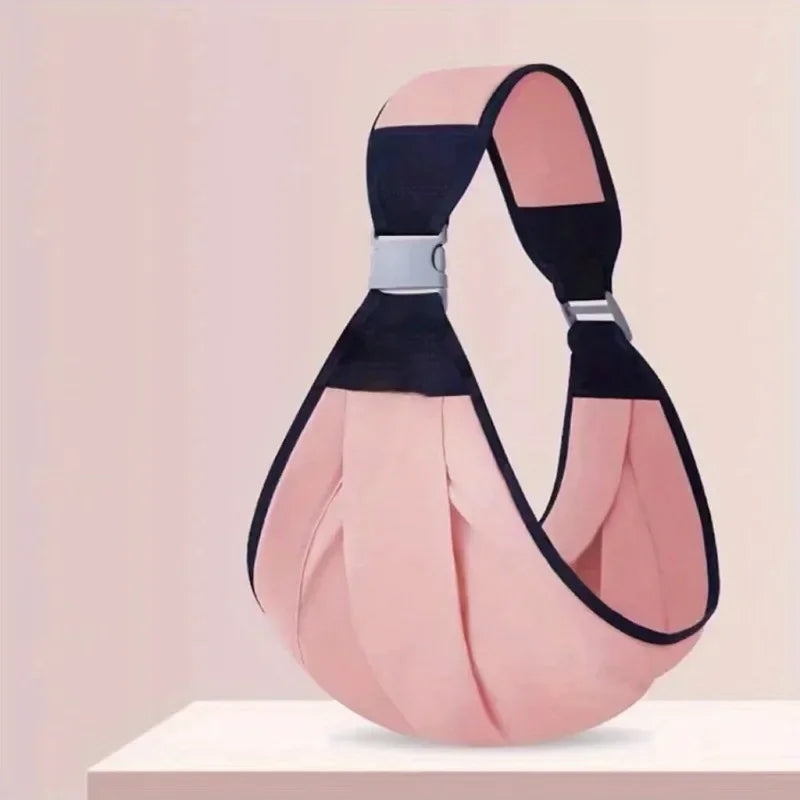 A pink and black adjustable cotton ring sling baby carrier displayed on a white surface.