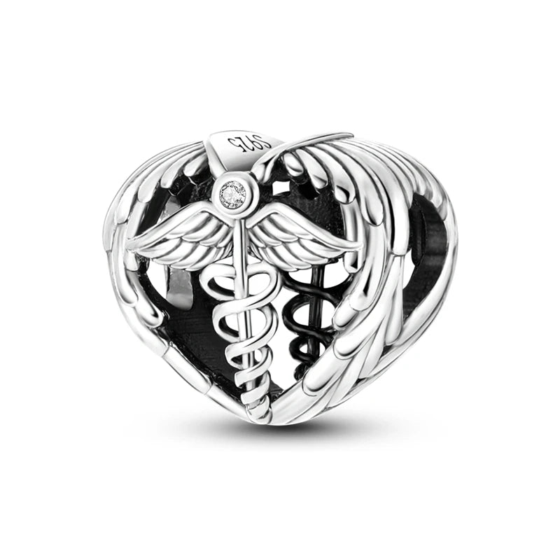 A sterling silver charm bead featuring a winged design and a central gemstone setting.