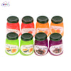 A set of five miniature ceramic jam jars in various fruit flavors including strawberry, apricot, and plum.