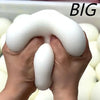 Hands holding a large white squishy bread stress ball with the word BIG visible above it.
