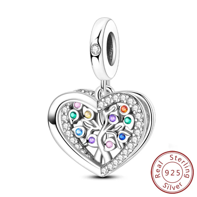 A sterling silver heart charm bead with a detailed floral design and small colored stones.