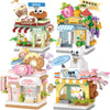 A set of mini city shop building blocks featuring various themed shops like a cafe, fruit stand, and candy store.