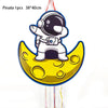 A pinata shaped like an outer space astronaut is shown, yellow and white, hanging by strings.