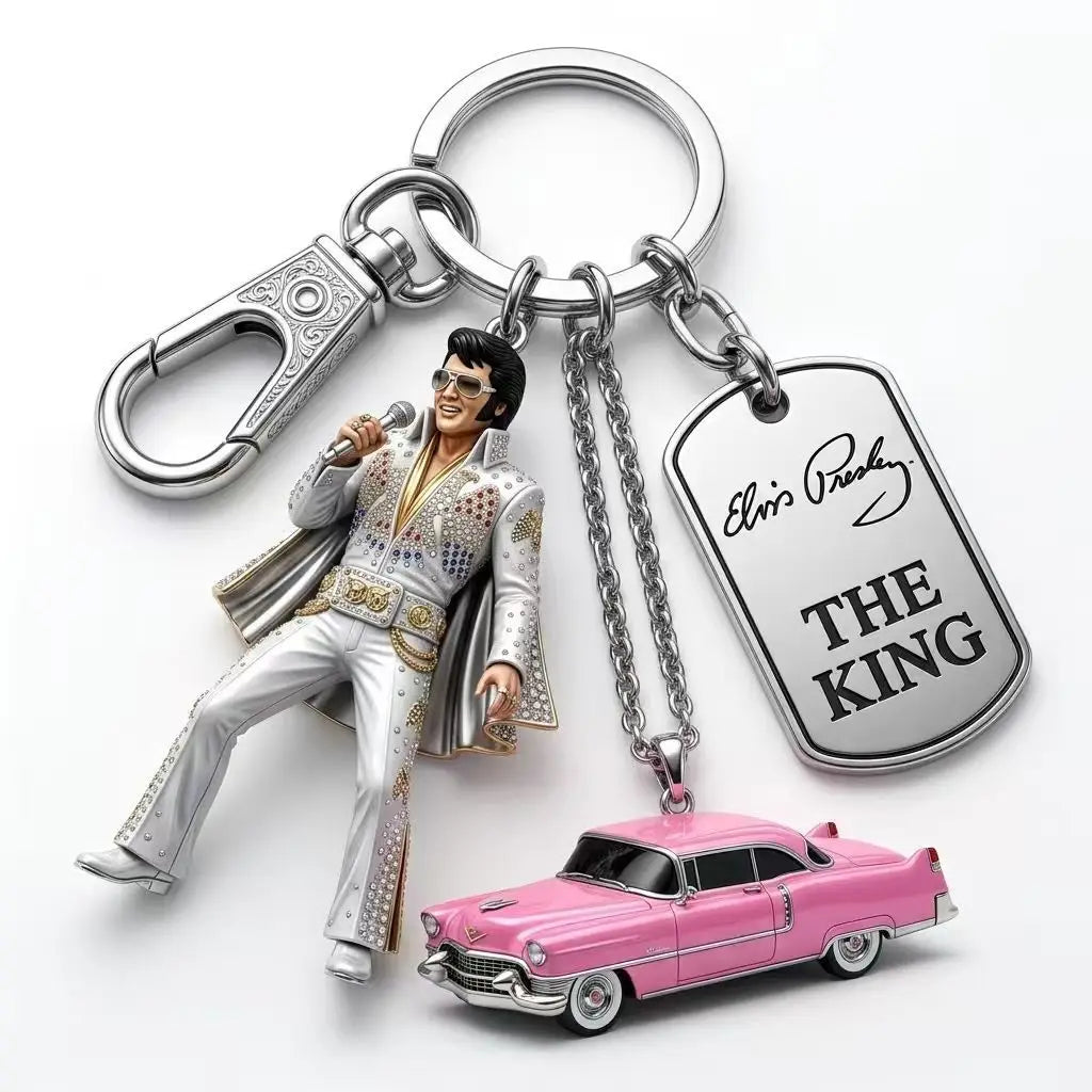 A silver keychain featuring a figurine of Elvis Presley in a suit and sunglasses.