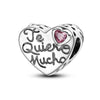 A heart-shaped sterling silver charm bead engraved with the text Te Quiero Mucho and featuring a pink zircon gemstone.