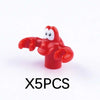 A bright red plastic marine animal building block shaped like a stylized sea creature.