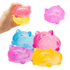 A hand holds a pink cat squishy toy next to a bright yellow one.