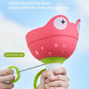 A hand is holding a pink flying saucer toy with a green pull ring, demonstrating its anti-pinch design.