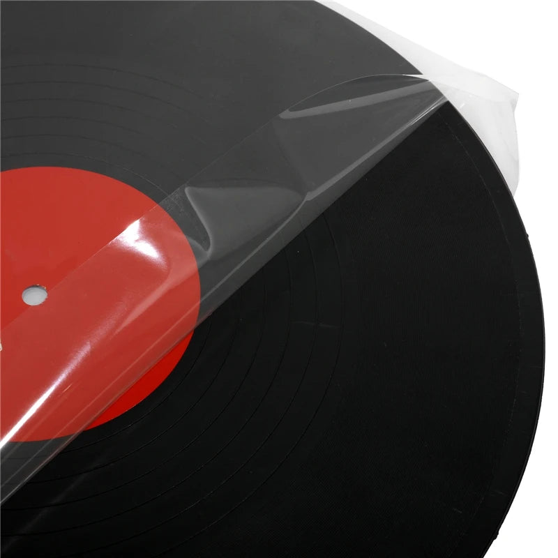 A black vinyl record disc is partially visible, covered by a clear self-adhesive sleeve with a red center label.