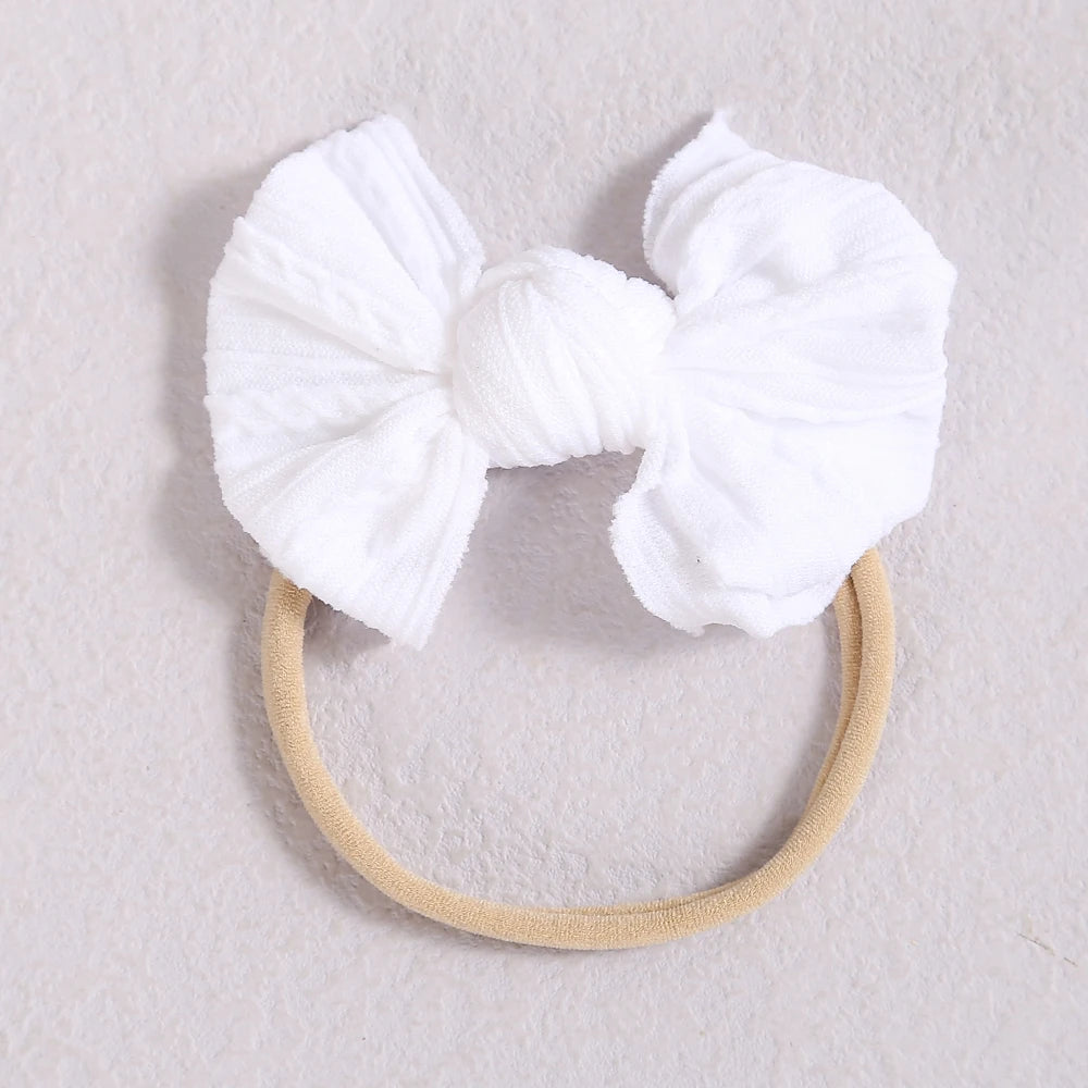 White soft elastic hair bands tied in a bow for girls