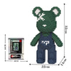 A green bear figure made of micro building blocks, standing upright with a white facial marking.