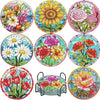 A set of floral diamond painting coasters featuring various colorful flowers and foliage with metal holders.