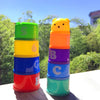 A stack of colorful plastic cups featuring numbers, letters, and shapes in various bright colors.