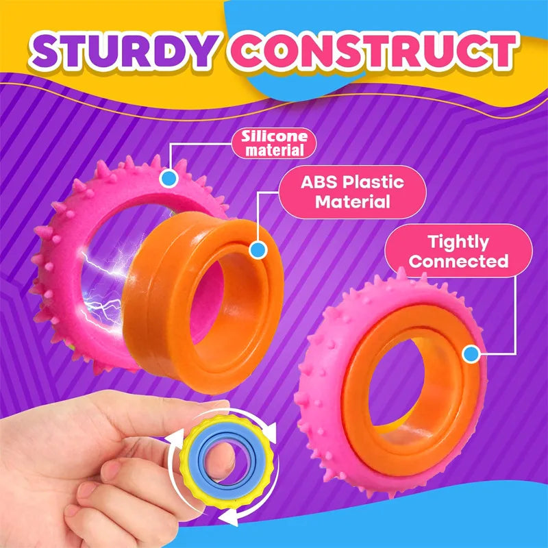 A hand holds a set of colorful silicone and ABS plastic fidget rings for stress relief.