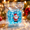 A clear plastic squeeze fidget cube inside a sealed bag featuring festive holiday figures like Santa and a snowman.