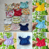 A collection of colorful and patterned clothing items for fashion dolls, including tops and dresses.