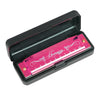 A pink and black harmonica with a colorful metal shell is shown in its open case.