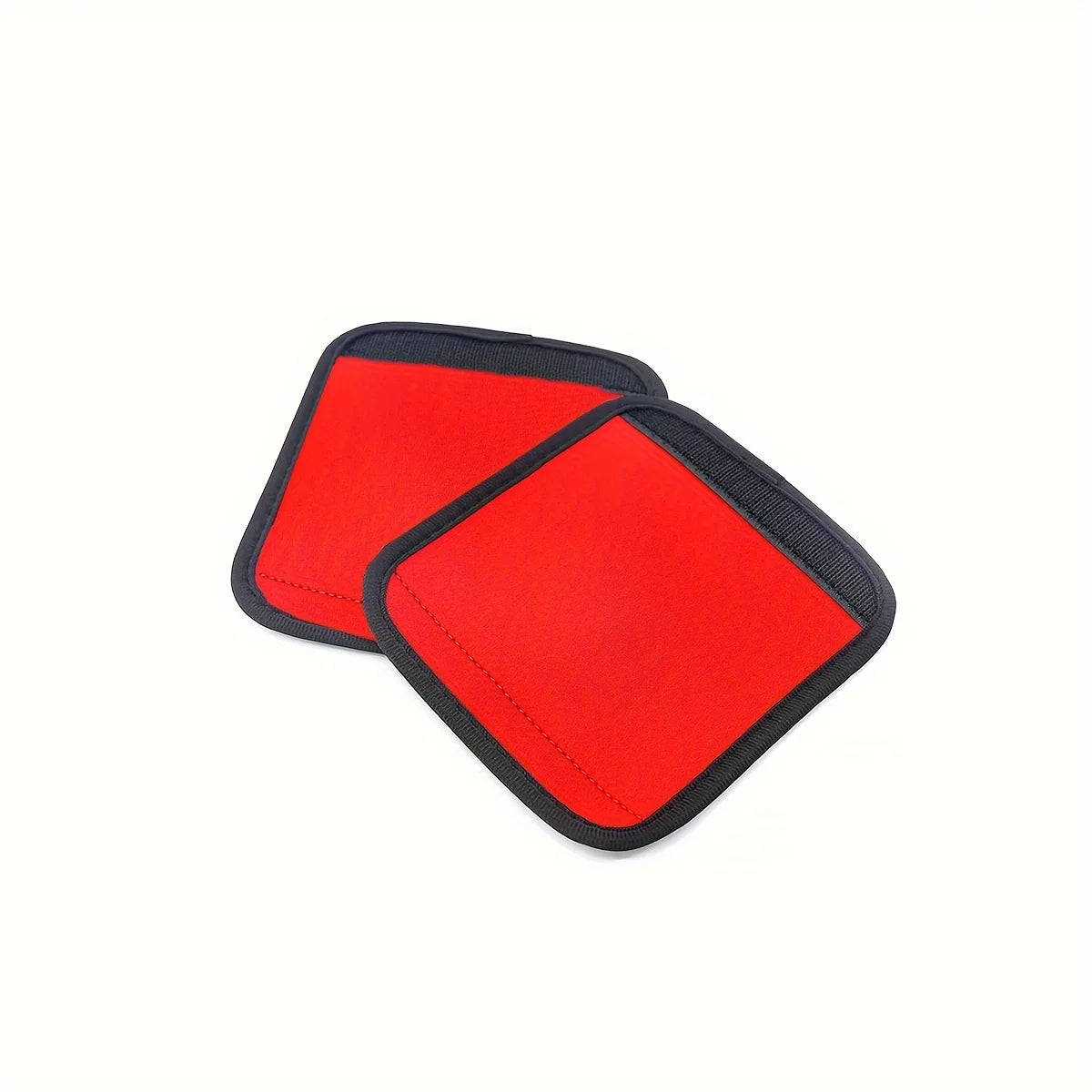A pair of red neoprene luggage handle covers with cushioned grips.