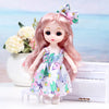 A pink doll with long hair and a floral dress is displayed next to a white piano.