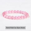 A bracelet made of natural pink quartz beads in a stretch style, arranged in a circle.