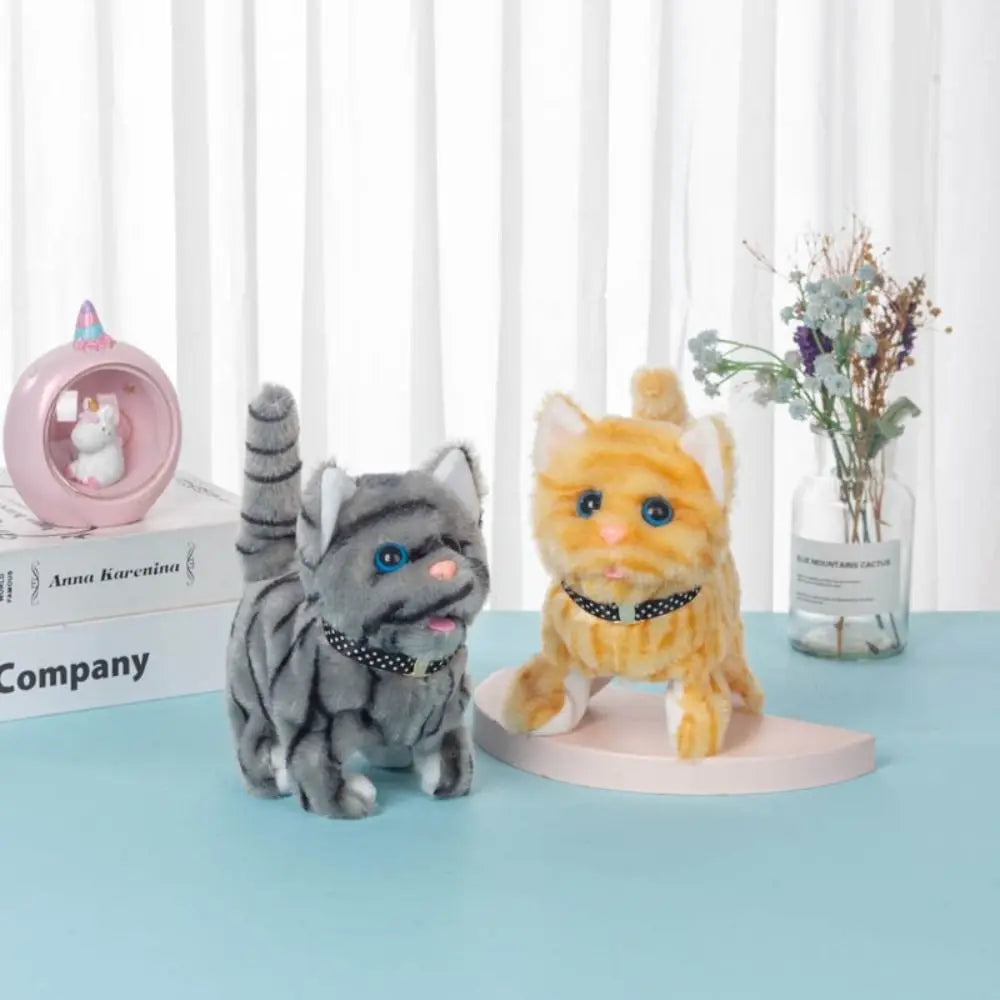 A fluffy orange cat plush toy sitting on a pink stand next to a glass vase of flowers.