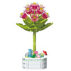 A green building block bouquet set featuring pink and purple rose flowers and various accessories.