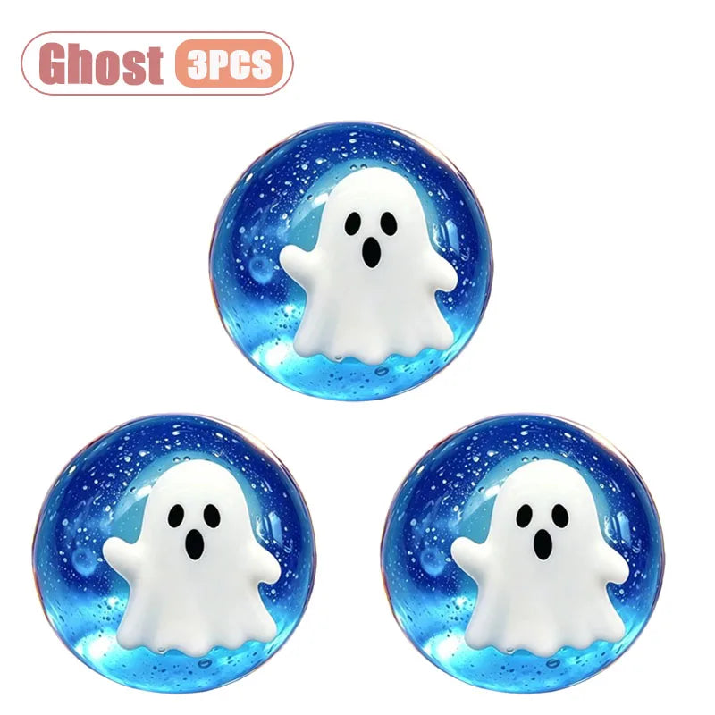 Three white ghost-shaped squishy stress relief toys with blue glitter accents