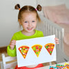 A smiling young girl holds up three colorful pizza-themed stickers on a white sheet of paper.