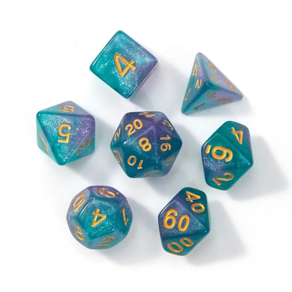 A set of seven polyhedral acrylic dice in various shades of teal and purple scattered on a white surface.