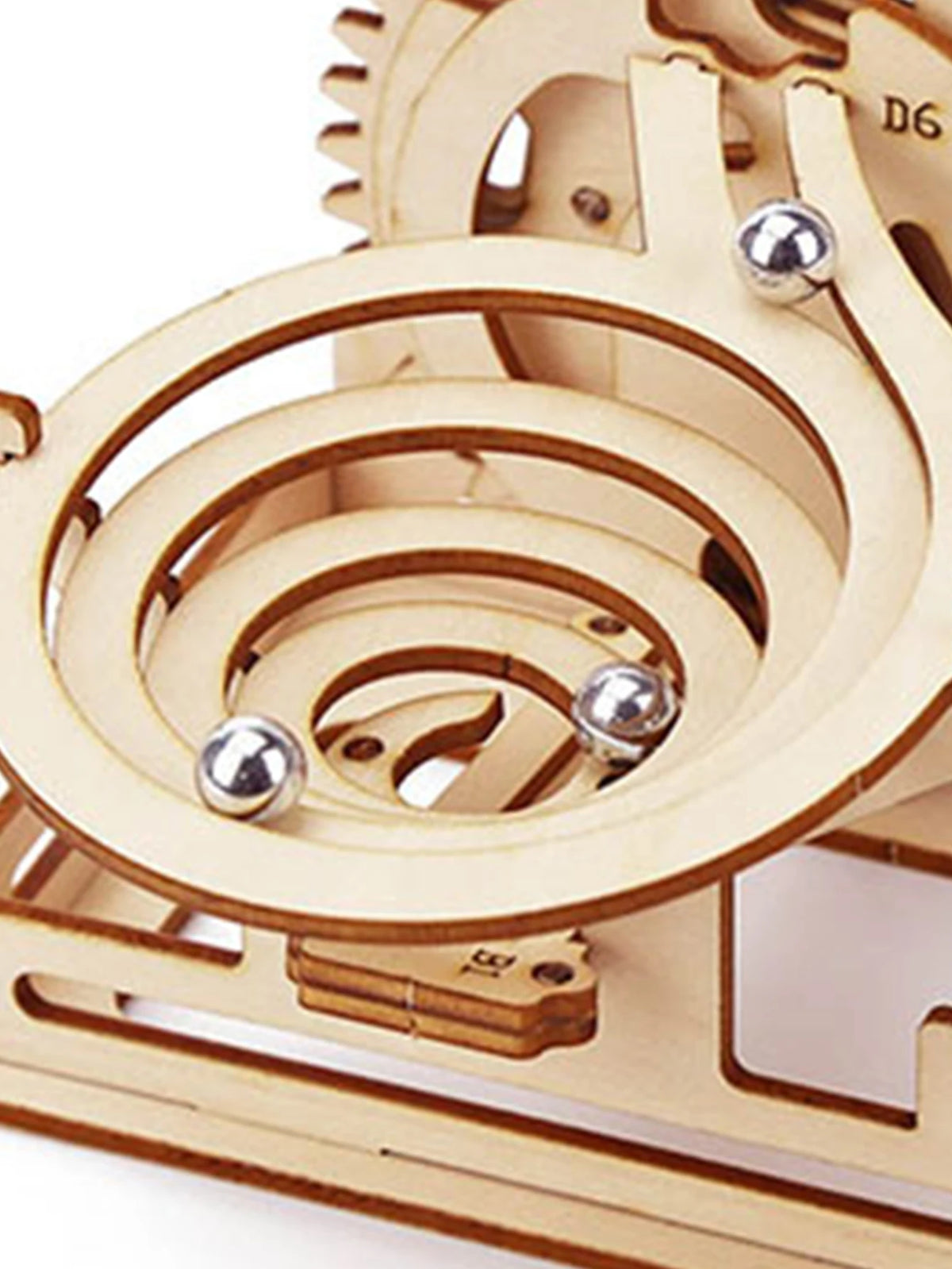 A wooden spiral marble run puzzle kit featuring wooden tracks and silver marble balls.