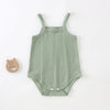 A light sage green lightweight cotton strappy romper for babies with a textured vertical pattern.