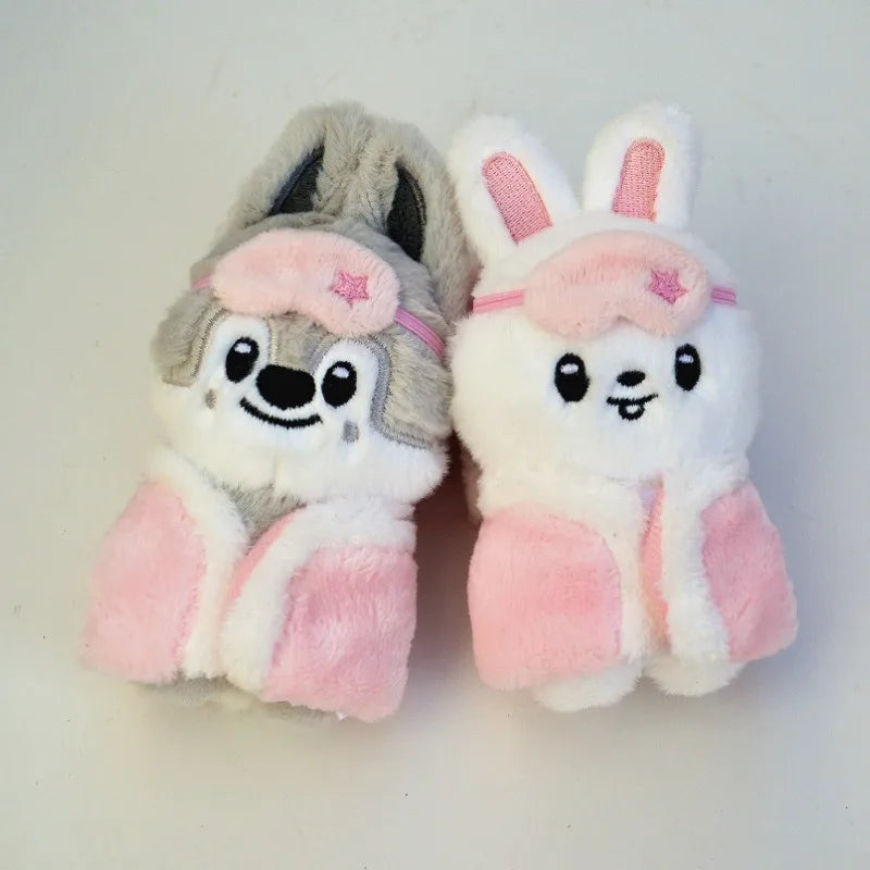 A pair of cute cartoon animal plush keychains featuring a gray bear and a white rabbit with pink accents.
