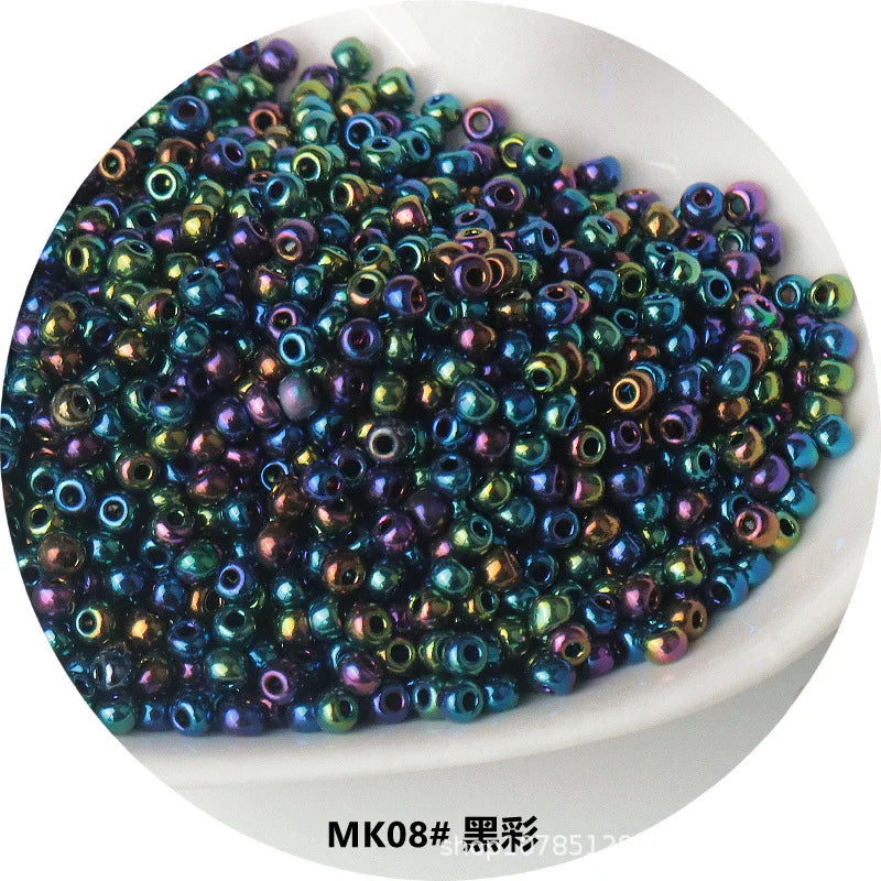 A pile of iridescent, metallic glass beads in various shades of blue and purple.