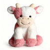 A white and pink plush toy of a cow with floppy ears and a smiling face.