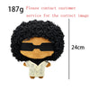 A plush doll resembling Eminem, XXXTentacion, and Frank Ocean with curly black hair and a light colored shirt.