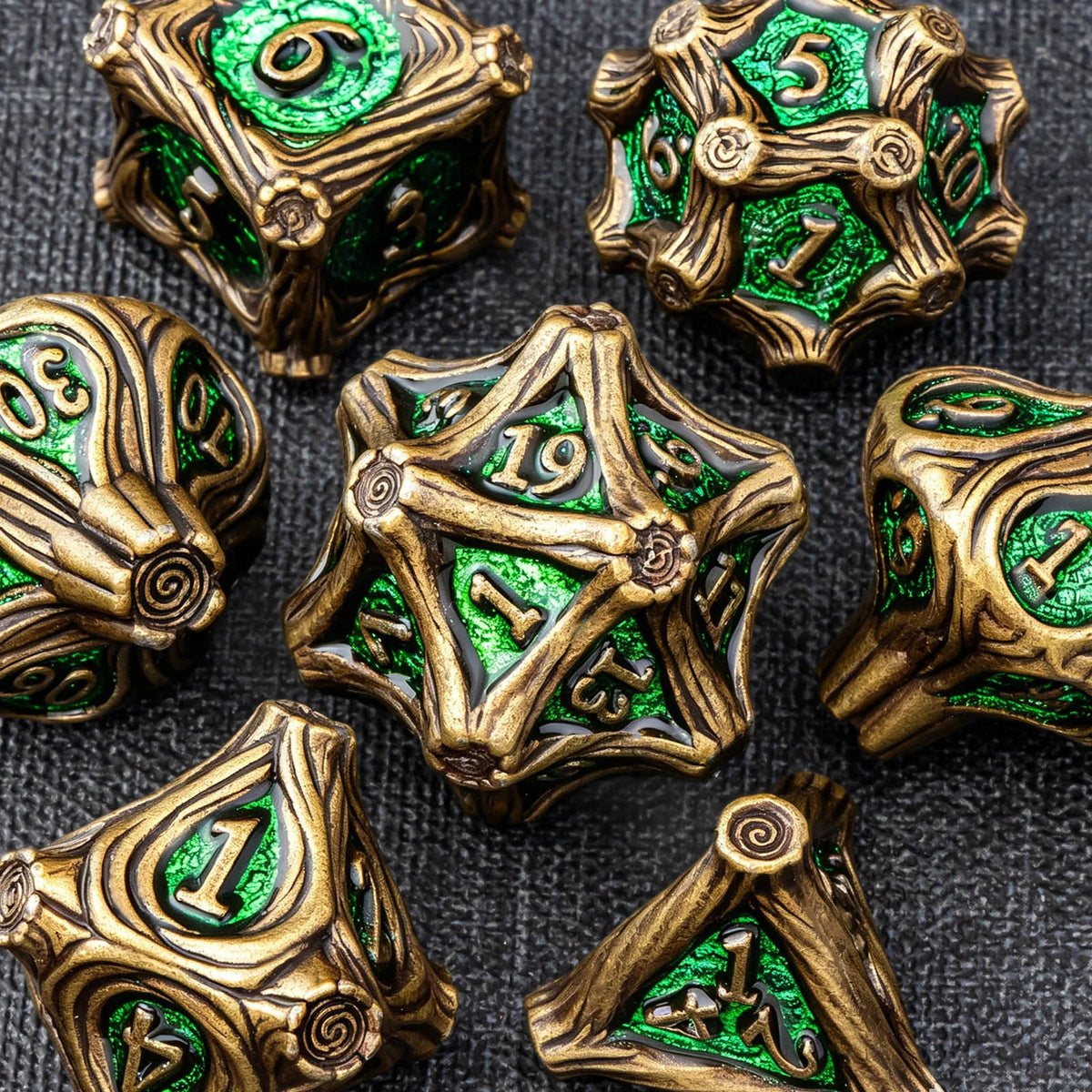A collection of gold and green metal dice set for tabletop role-playing games