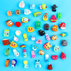 A collection of colorful surprise capsule egg toys featuring mixed animal and cartoon figures for party favors.