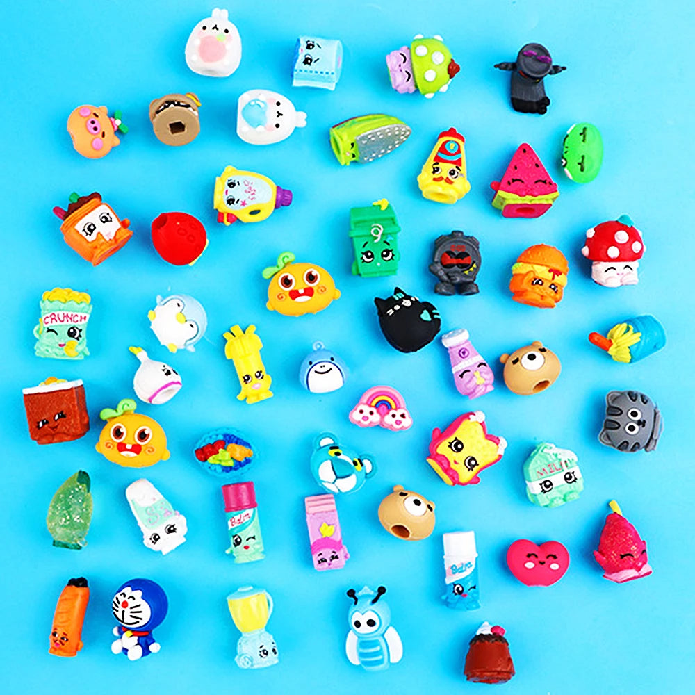 A collection of colorful surprise capsule egg toys featuring mixed animal and cartoon figures for party favors.