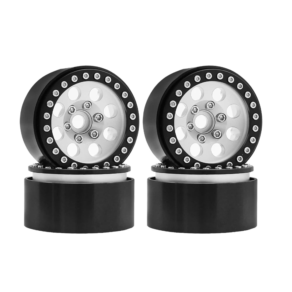 A pair of black beadlock wheels with a silver hub and removable hex hub for an RC crawler.