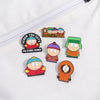 A set of enamel pins featuring characters from South Park, including Cartman and Stan.