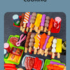 A colorful kids pretend play BBQ grill set featuring various toy foods like meat, vegetables, and bread.