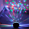 A starry night light projector casts colorful, rotating celestial scenes onto a surface.