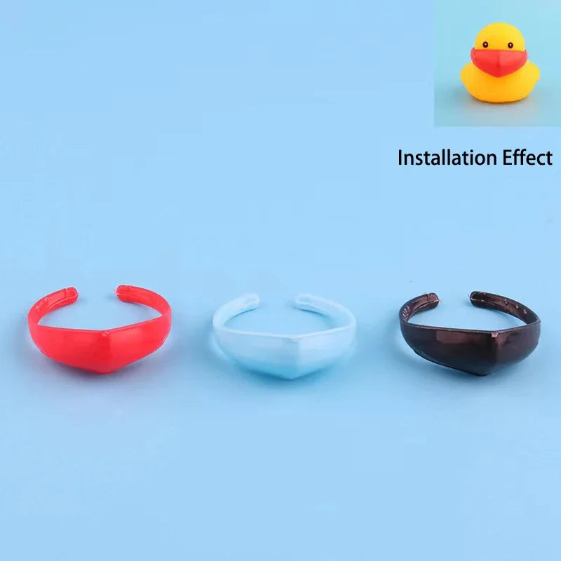 A set of three rubber duck accessories in red, white, and black, demonstrating an installation effect.