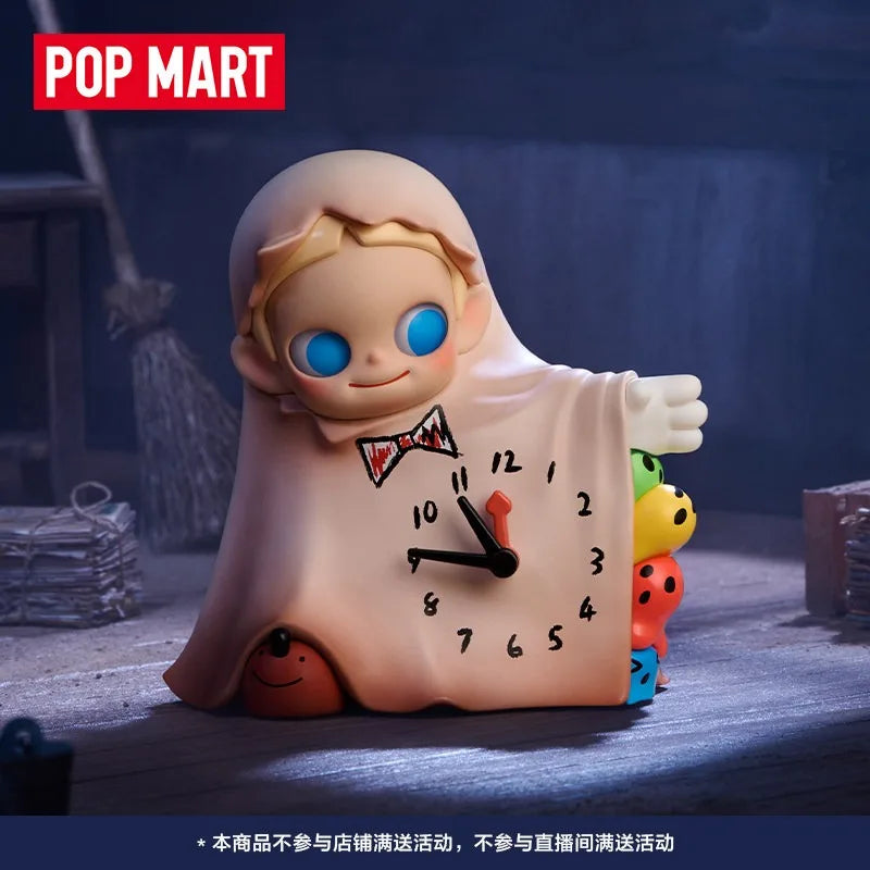 A blind box collectible figure of a baby with blue eyes wearing a light pink hooded garment.