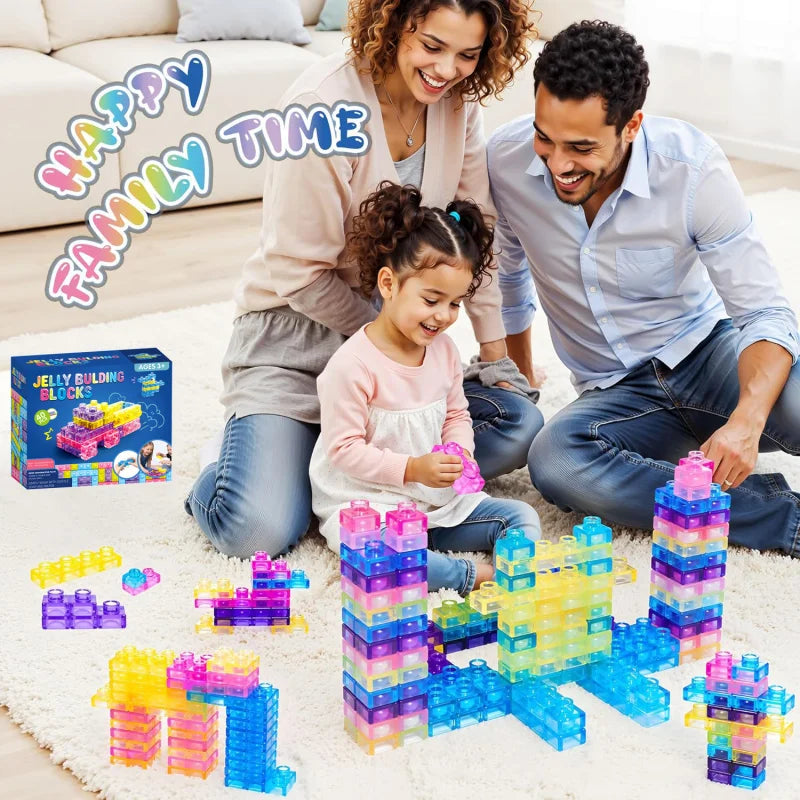 A family is playing with a colorful set of jelly building blocks on a white rug.