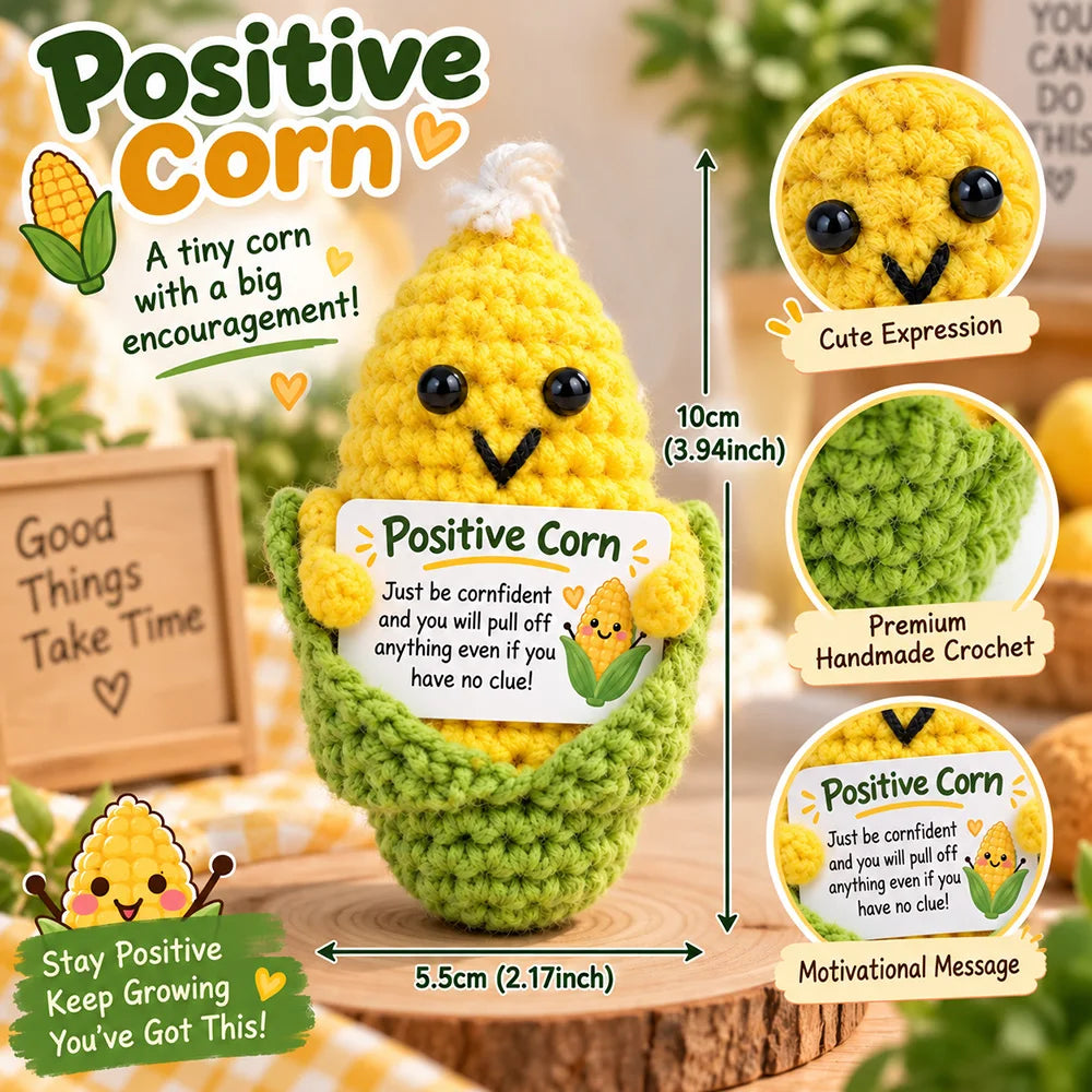 A yellow crocheted corn mascot with a motivational message card and a green textured body.